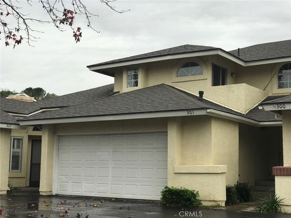 Front view of a two-story house with a garage.