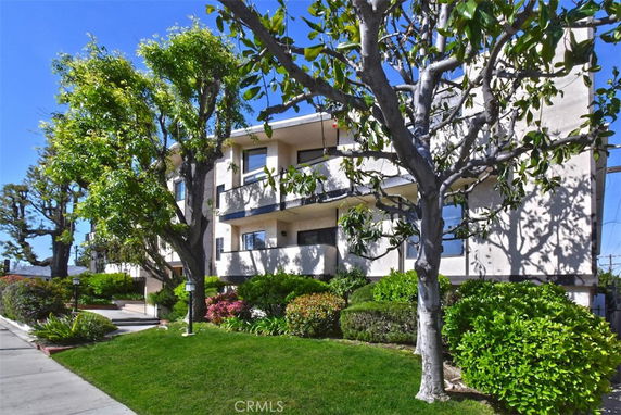 Front view of a multi-story residential building with balconies.
