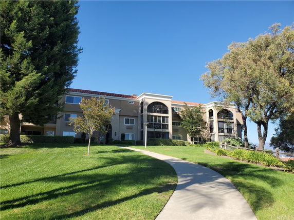 Front view of a multi-story building with arched balconies.