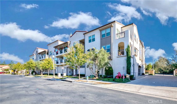 Front view of a multi-story residential building with balconies.