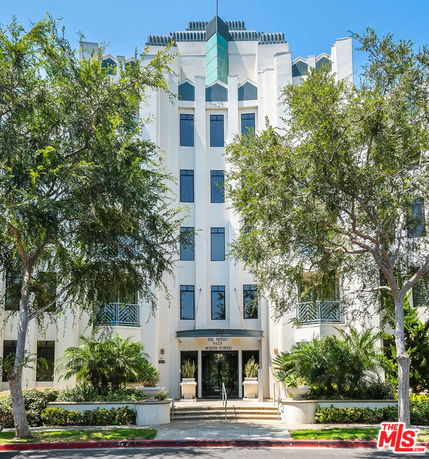 Front view of a multi-story building with modern architectural design.