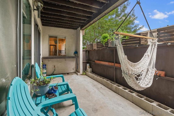 Outdoor patio area with hammock and chairs.