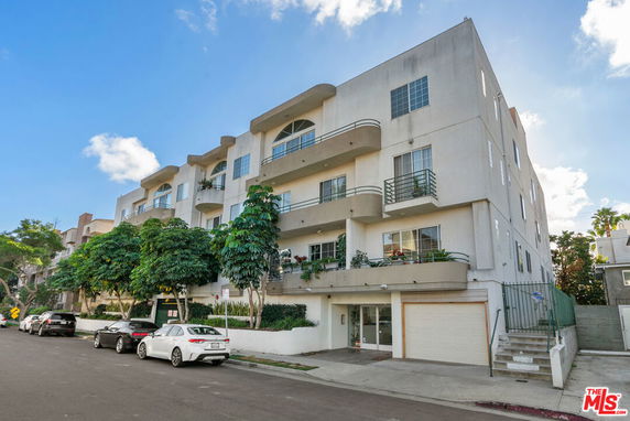 Front view of a multi-story residential building with balconies.