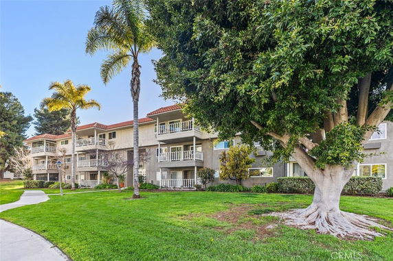 Front view of a multi-story residential building with balconies.