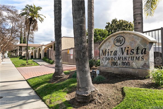 Front view of a condominium building with a sign reading 'Mira Vista Condominiums'.