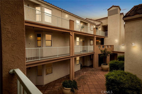 View of a multi-story building with balconies and exterior walkways.