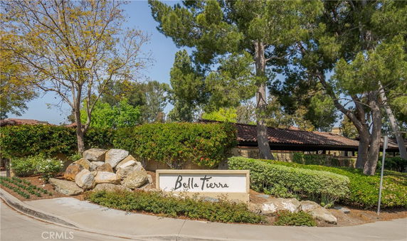 Front view of a building with a visible sign reading 'Bella Terra' surrounded by trees and landscaping.