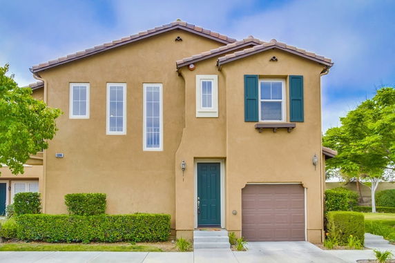 Front view of a two-story house with a single garage.