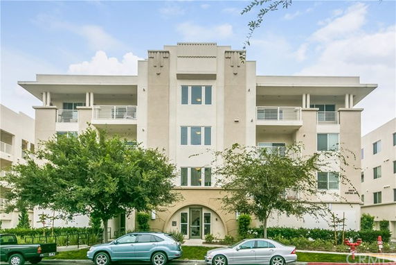 Front view of a multi-story residential building with balconies.