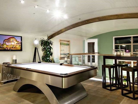 Room with a pool table and modern decor