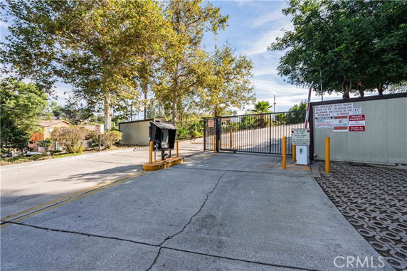 Entrance of an outdoor gated parking area.