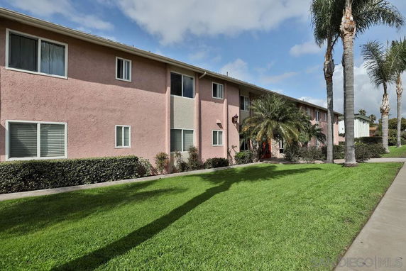 Front view of a two-story apartment building with a pink exterior.