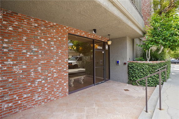 Front view of a building entrance with brick and glass exterior.