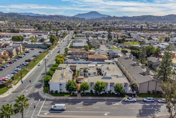 Aerial view of a suburban area with multiple residential buildings and roads.