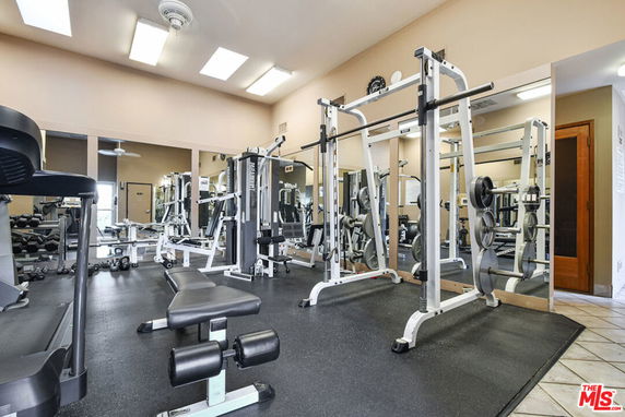 Interior view of a gym with various exercise equipment.