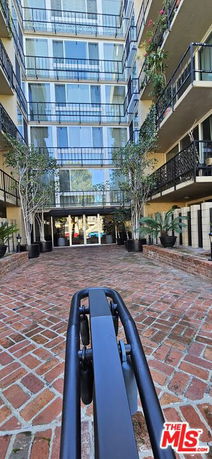 Front view of a multi-story residential building with balconies.