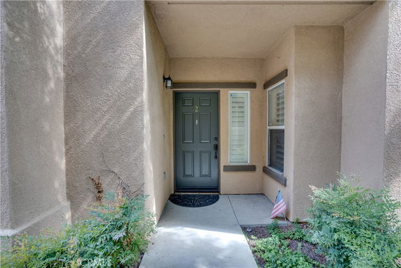 Front entrance view of a house with a sheltered doorway.