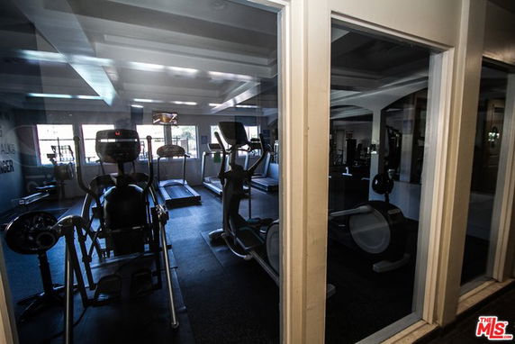 Interior view of a gym with exercise equipment and treadmills.