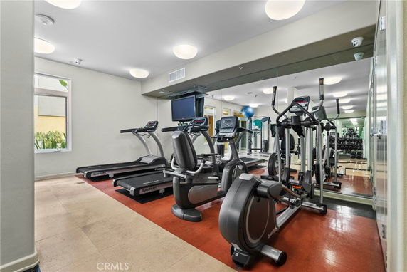 Interior view of a gym with exercise equipment like treadmills and ellipticals.