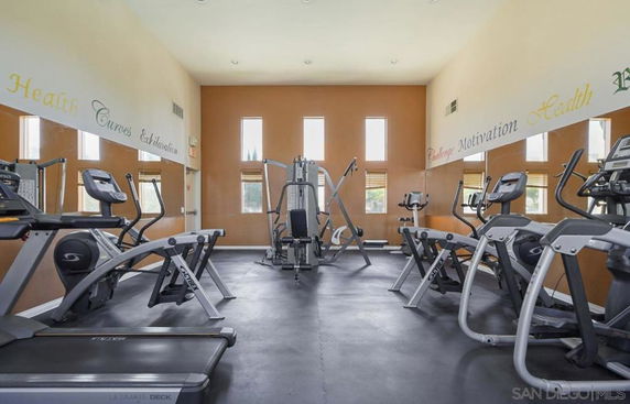 Indoor gym area with various exercise equipment including treadmills and ellipticals.