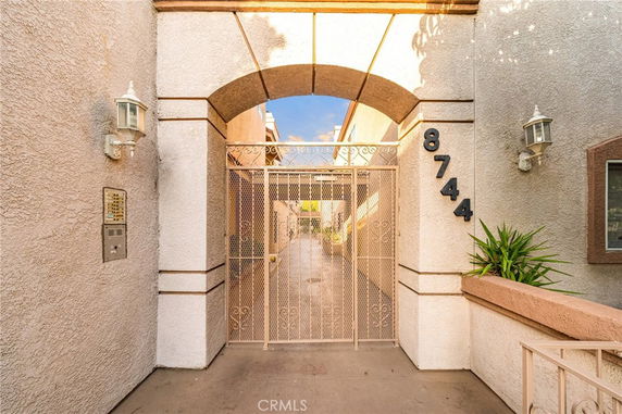 Entrance gateway of a building with a metal gate and archway.