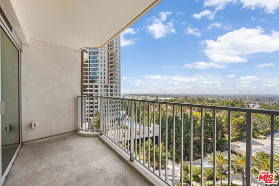 View from a balcony overlooking surrounding buildings and landscape