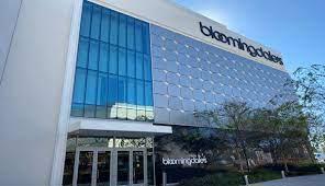 Front view of a modern commercial building with large glass panels and an entrance.