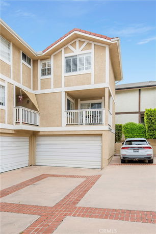 Front view of a multi-story house with a double garage.
