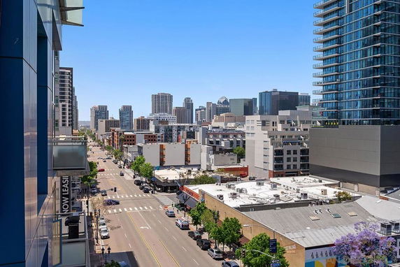 Panoramic view of a cityscape with tall buildings and streets.