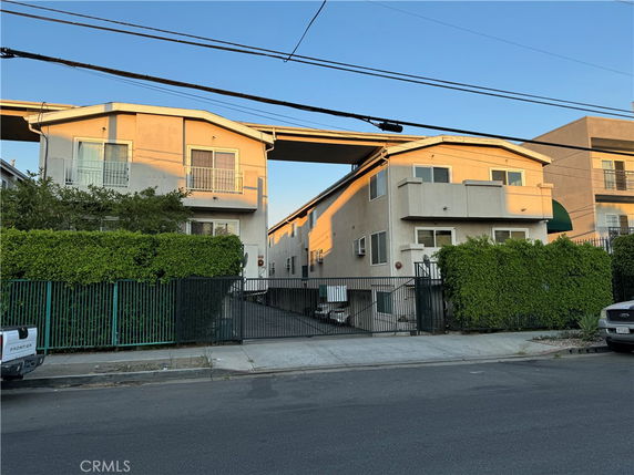 Front view of a two-story apartment building with balconies.