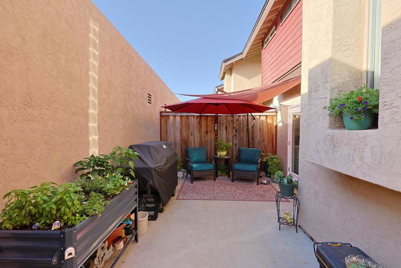 Outdoor patio area with seating and plants.