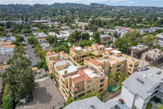 Aerial view of a residential area with apartment buildings and surrounding greenery.