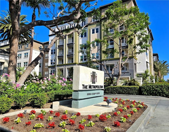 Front view of a multi-story residential building with modern architecture.