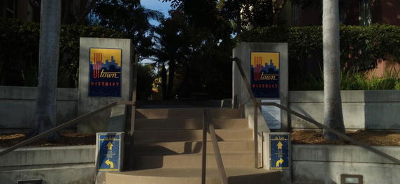 Entrance of a district with stairs and signage.
