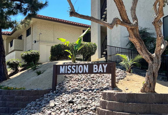 Front view of a residential building with a sign reading 'Mission Bay'.