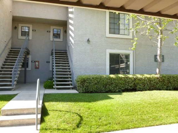 Front view of a residential building with external staircases.