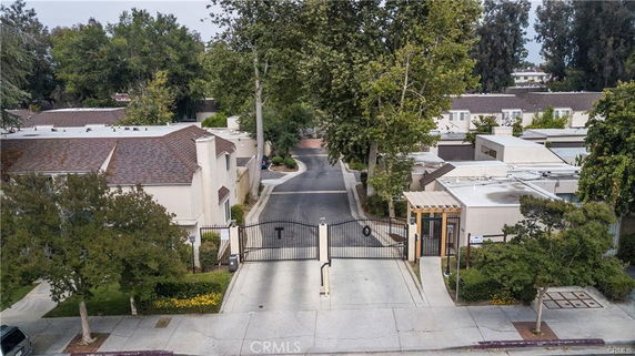 Front view of a gated residential complex with multiple houses.