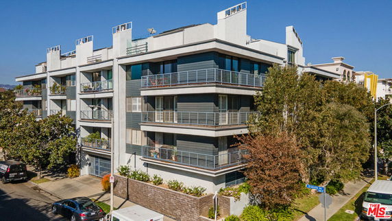 Front view of a multi-story residential building with balconies.