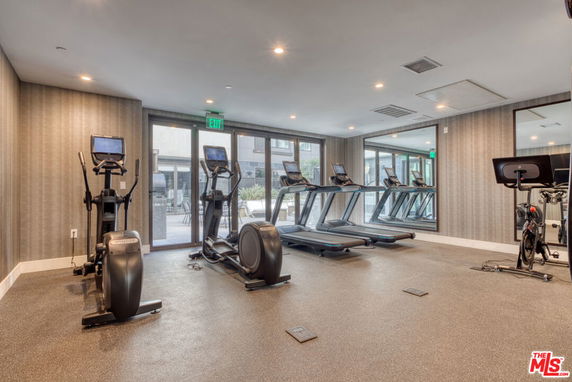 Indoor gym area with exercise equipment and treadmills.