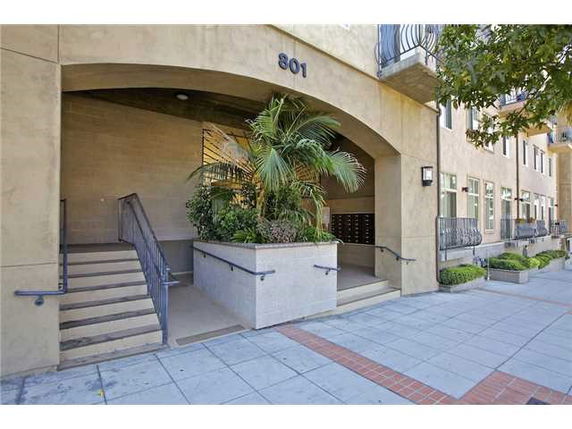 Front entrance of a building with stairs and planter.
