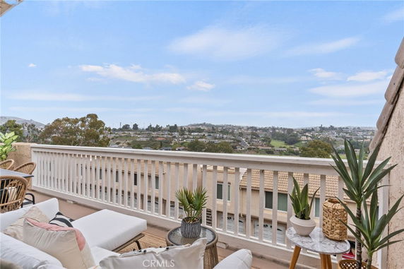 Panoramic view of a residential area seen from a balcony with outdoor seating.