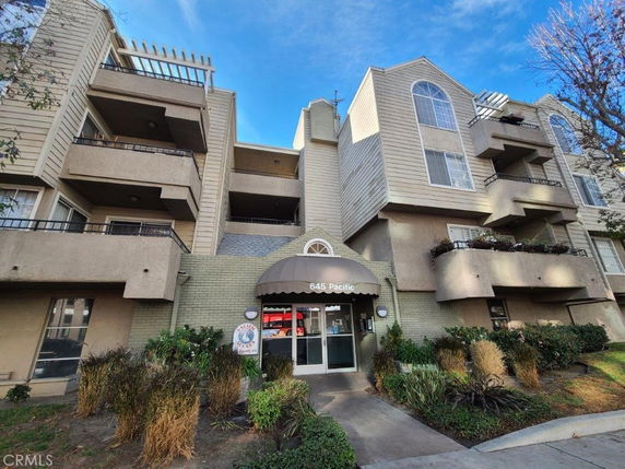 Front view of a multi-story residential building with balconies.