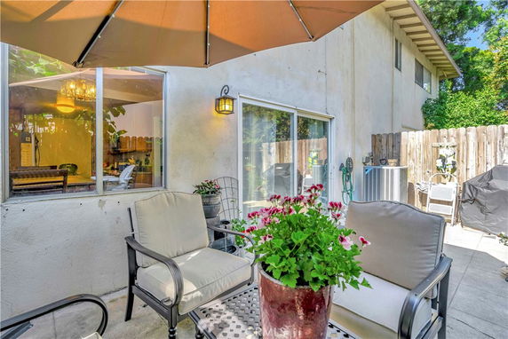 Patio area of a house with sliding glass door and window.