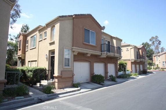 Front view of a two-story residential building with multiple garages.