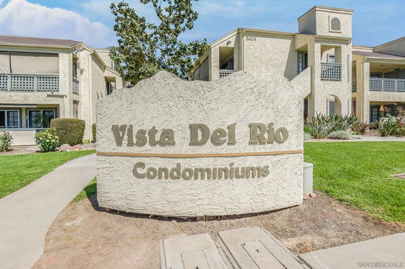 Front view of a condominium building with a sign reading 'Vista Del Rio Condominiums.'
