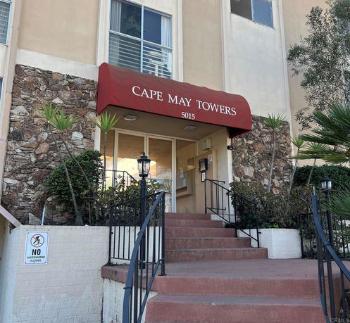 Front view of a building entrance with a red canopy labeled 'Cape May Towers'.