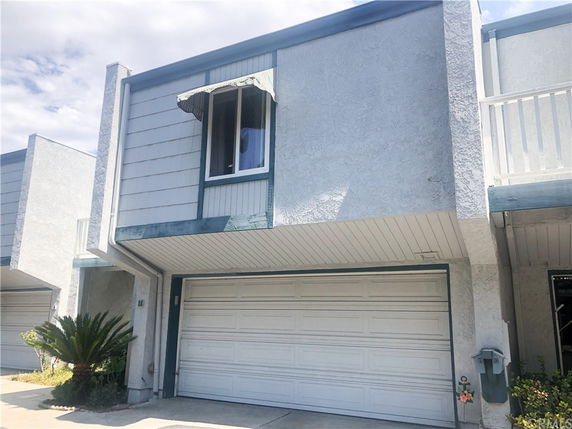 Front view of a two-story building with a garage.