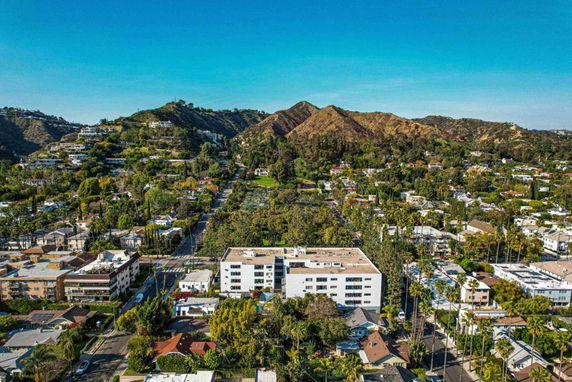 Panoramic view of a cityscape with hills and buildings.