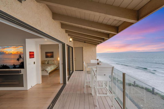 Balcony with ocean view and outdoor seating.
