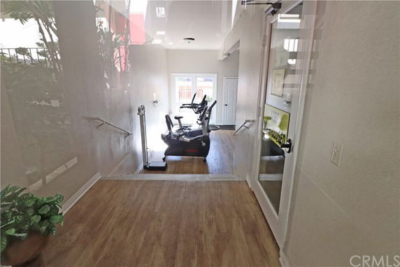 Indoor gym area with exercise bikes and a wooden floor.